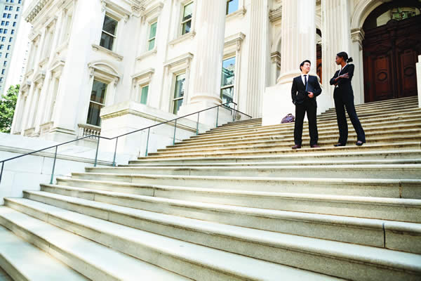 people standing on stairs outside of courthouse