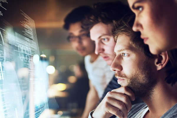 group of people viewing computer monitors